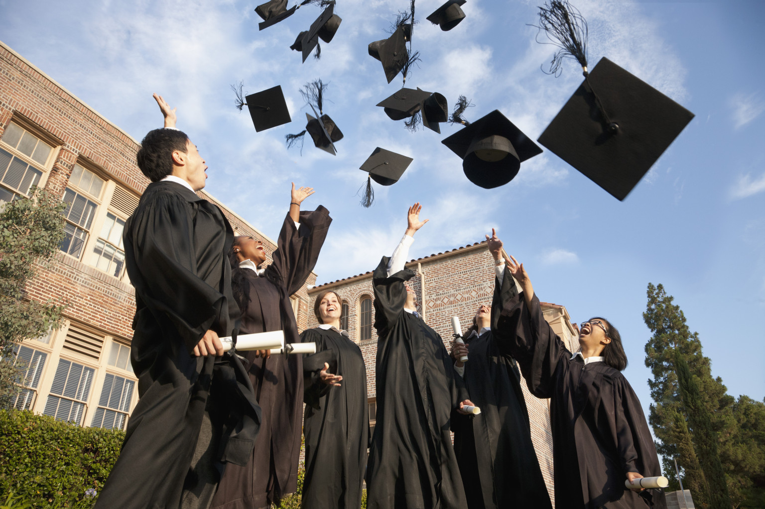 Graduates throwing hats in the air