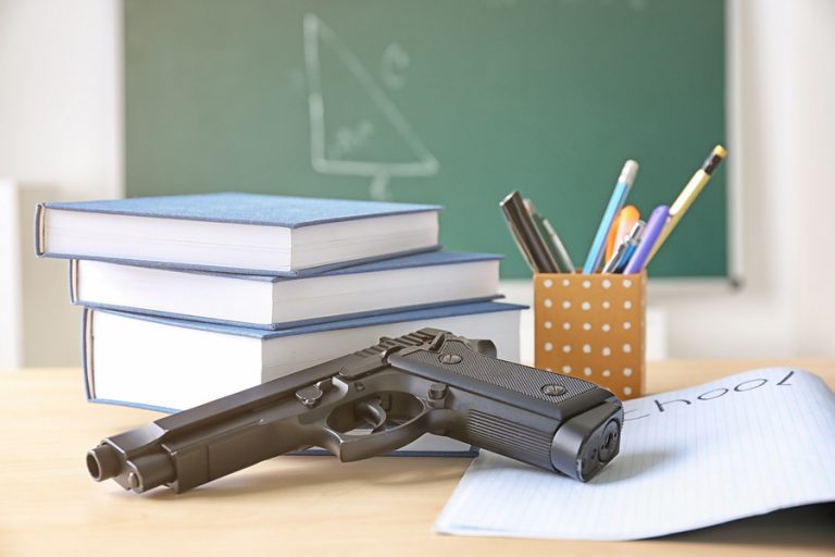 bigstock-School-stationery-and-gun-on-t-175638457-768x512